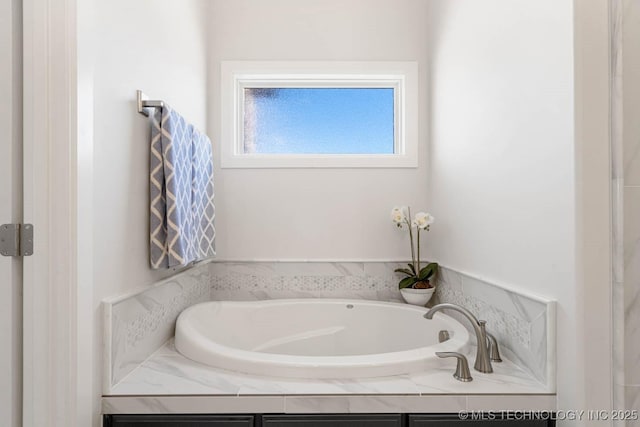 bathroom with a relaxing tiled tub