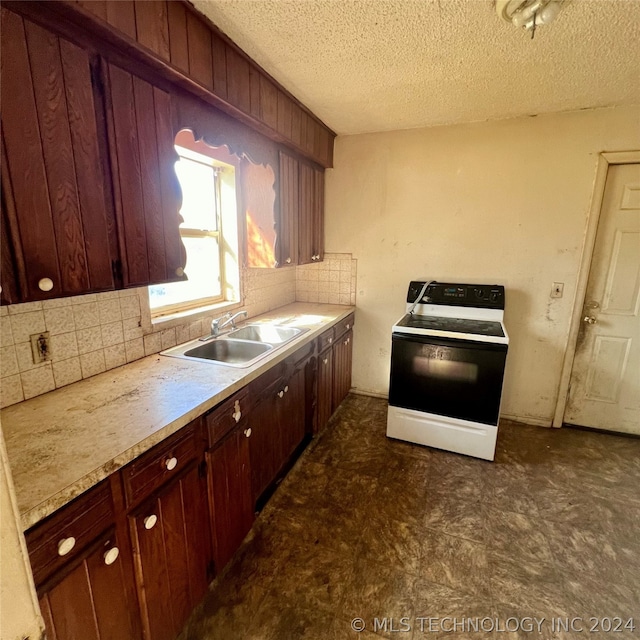 kitchen featuring white electric range, tasteful backsplash, dark tile flooring, sink, and a textured ceiling