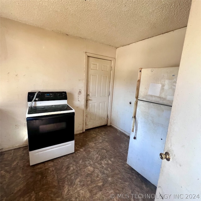 kitchen with white appliances and a textured ceiling