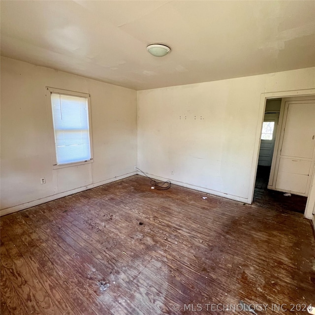 spare room with dark hardwood / wood-style flooring