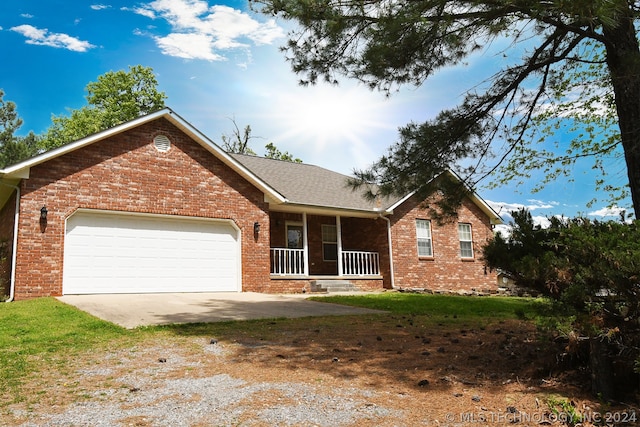 ranch-style house with a garage and a porch