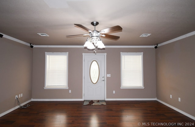 entrance foyer featuring plenty of natural light, ceiling fan, dark hardwood / wood-style floors, and crown molding