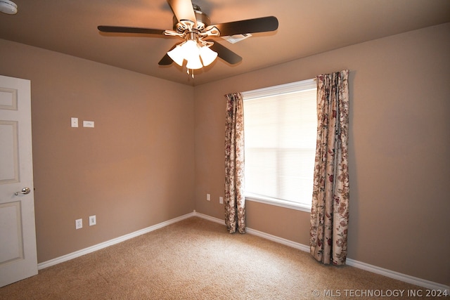 spare room featuring ceiling fan and carpet flooring