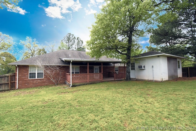 back of property featuring a lawn