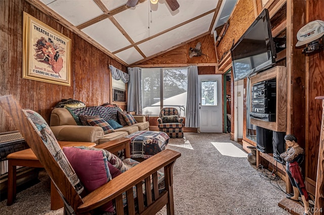 living room featuring high vaulted ceiling, ceiling fan, carpet floors, and wood walls