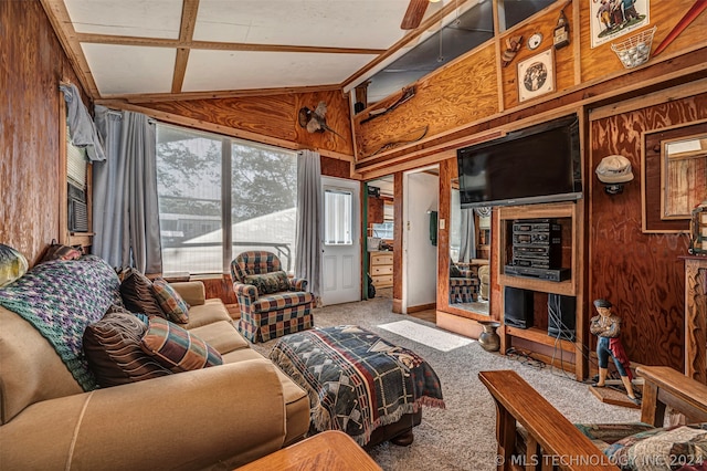 living room featuring carpet flooring, wooden walls, and lofted ceiling