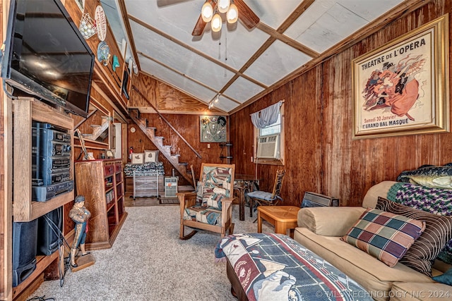 carpeted living room featuring wooden walls, ceiling fan, and vaulted ceiling