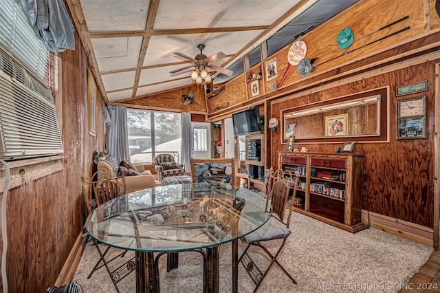 carpeted dining area with coffered ceiling, wooden walls, ceiling fan, and lofted ceiling with beams