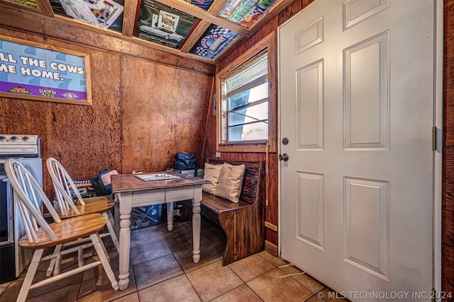 interior space with wooden walls and tile floors