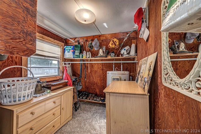 carpeted bedroom featuring wood walls