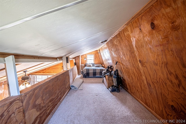 interior space featuring carpet flooring, wooden walls, and vaulted ceiling