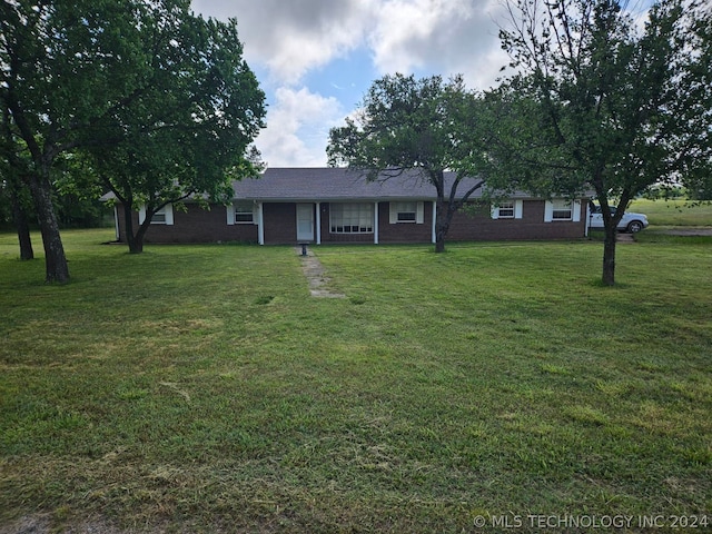 ranch-style home with a front lawn