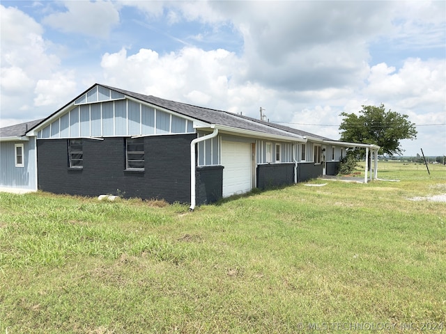 view of side of home with a yard