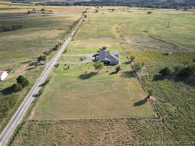 birds eye view of property with a rural view