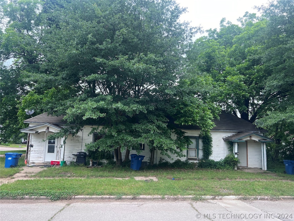 obstructed view of property with a front yard