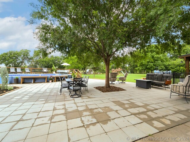 view of patio featuring outdoor lounge area and a pool