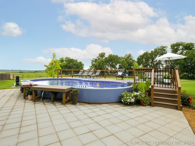 view of swimming pool with a deck