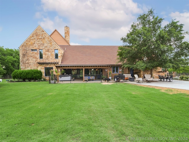 rear view of house with a patio area and a yard