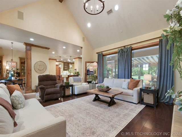 living room with dark hardwood / wood-style floors, high vaulted ceiling, and a notable chandelier