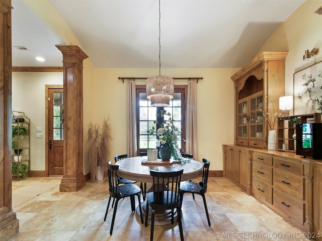 dining room featuring ornate columns