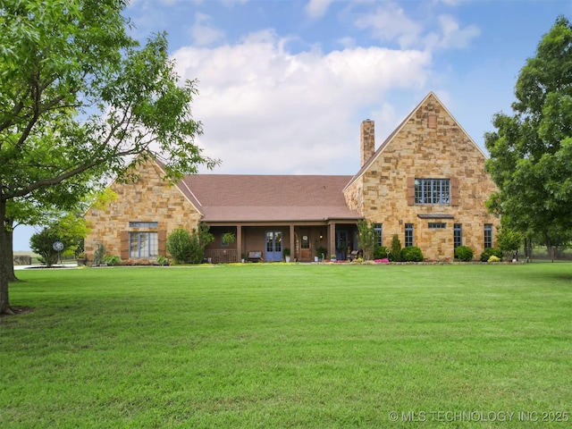 view of front facade featuring stone siding, a front lawn, and a chimney