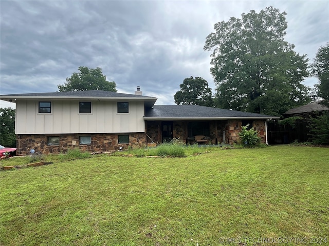 rear view of house with a yard