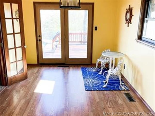 entryway featuring a healthy amount of sunlight, french doors, and hardwood / wood-style floors