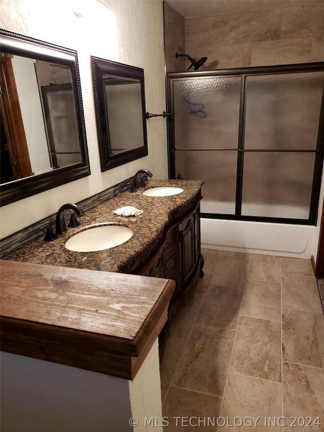 bathroom with tile flooring, dual sinks, and large vanity