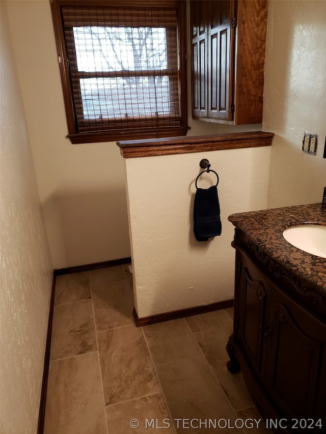 bathroom with tile floors and vanity