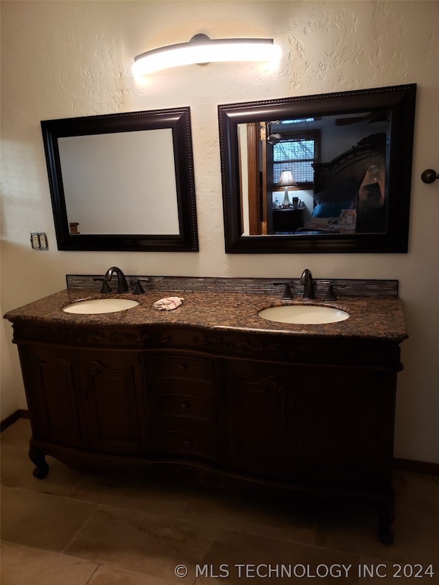 bathroom featuring tile flooring and double sink vanity