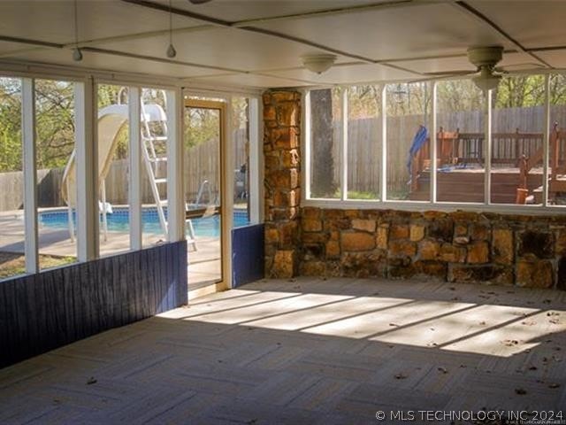 unfurnished sunroom with a wealth of natural light