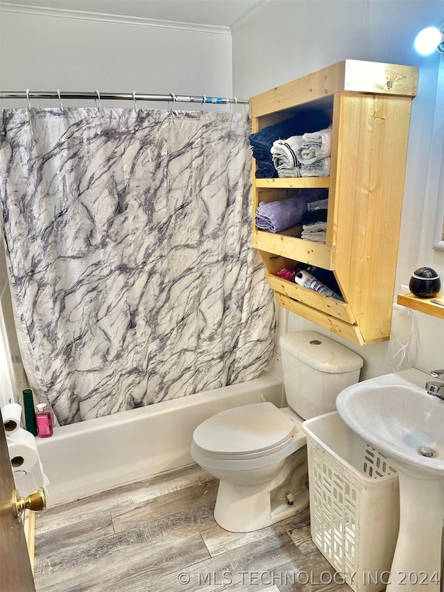 bathroom with shower / bath combo, crown molding, hardwood / wood-style flooring, and toilet