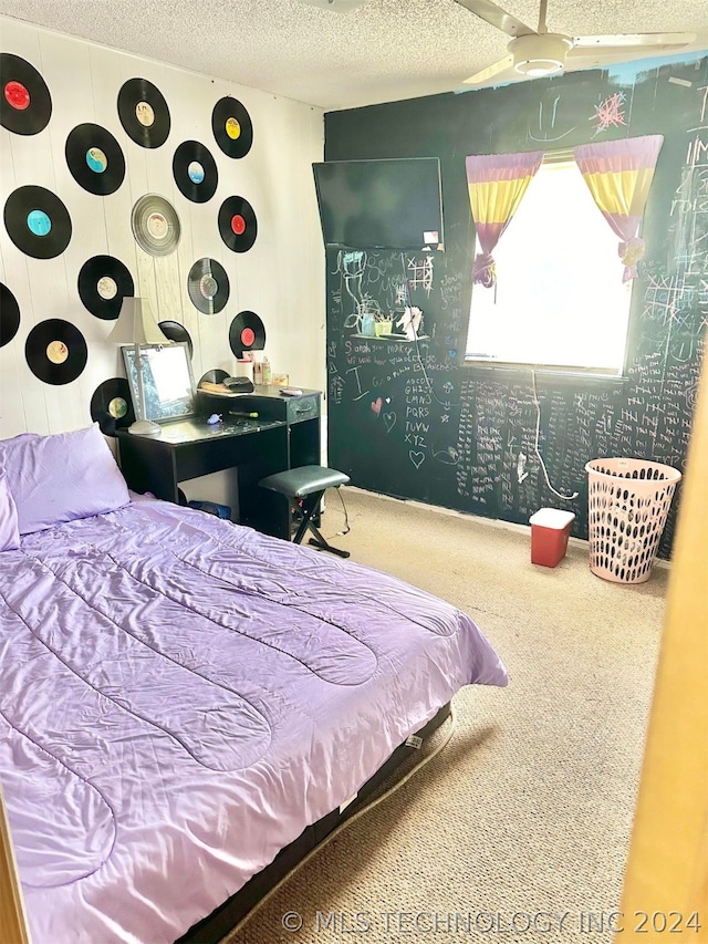 carpeted bedroom featuring a textured ceiling and ceiling fan