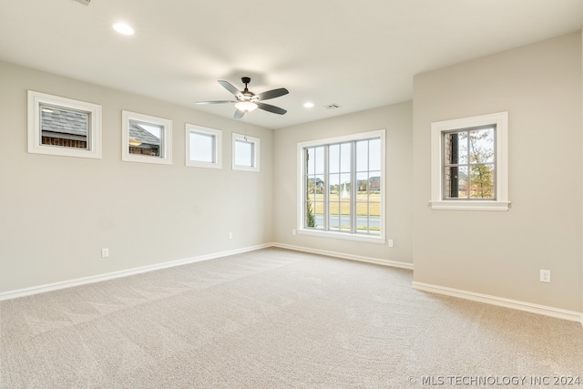 carpeted spare room with ceiling fan