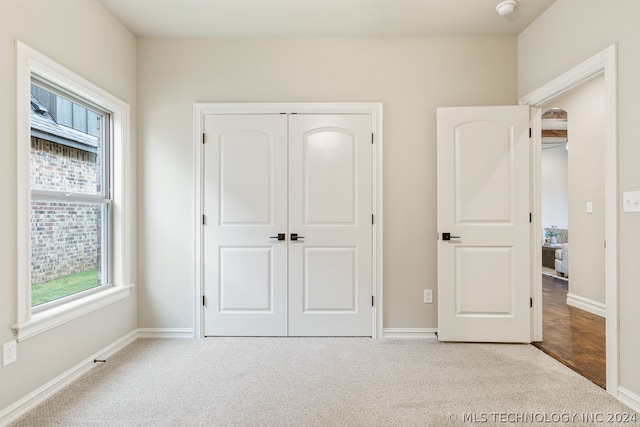 unfurnished bedroom featuring a closet and light tile flooring