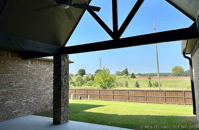 view of yard with ceiling fan and a patio