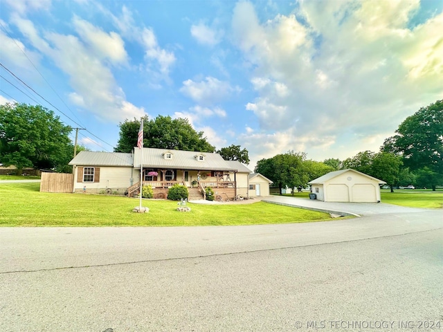 view of front of home with a front yard, an outdoor structure, a porch, and a garage