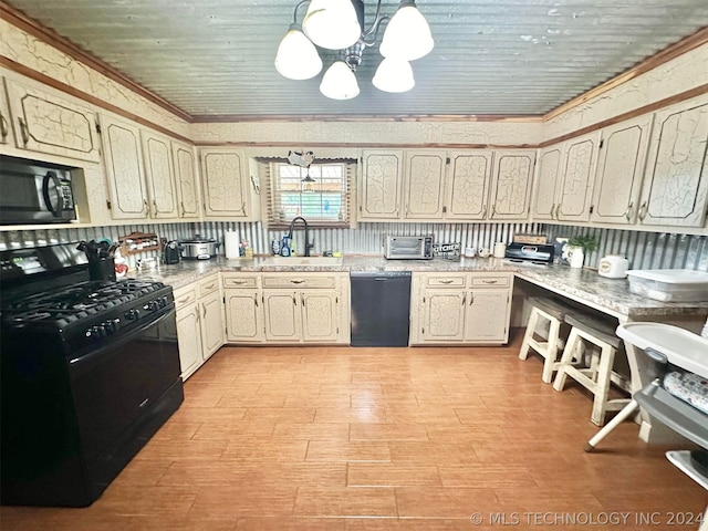 kitchen with sink, black appliances, a chandelier, and ornamental molding