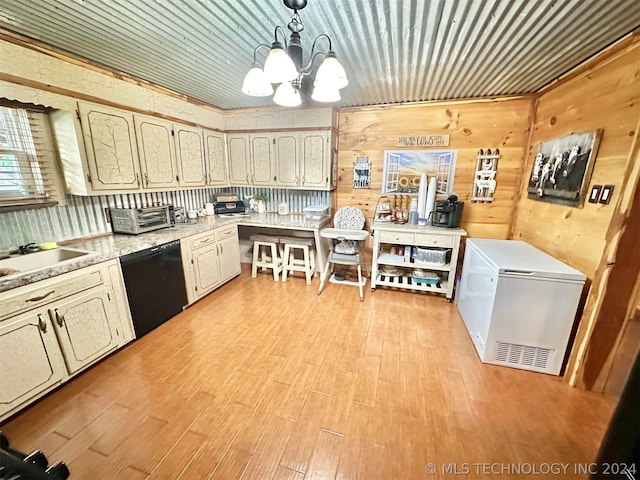 kitchen with dishwasher, a notable chandelier, refrigerator, light wood-type flooring, and wooden walls