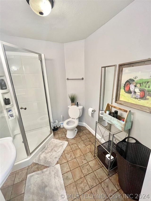 bathroom with sink, tile flooring, a shower with shower door, and toilet