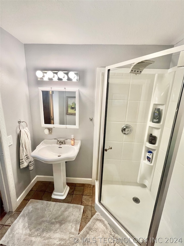 bathroom with walk in shower and tile flooring