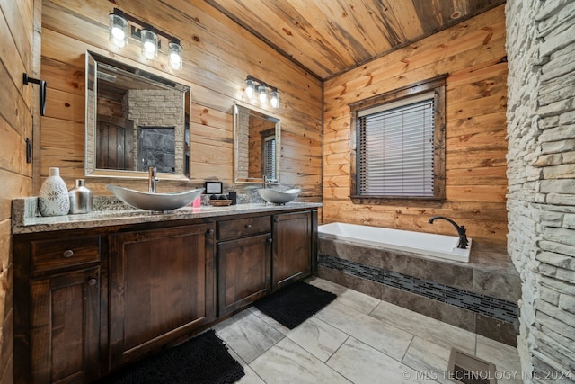 bathroom featuring a relaxing tiled bath, dual vanity, tile floors, wooden walls, and wooden ceiling