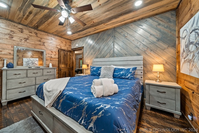 bedroom with wooden ceiling, dark wood-type flooring, wooden walls, and ceiling fan