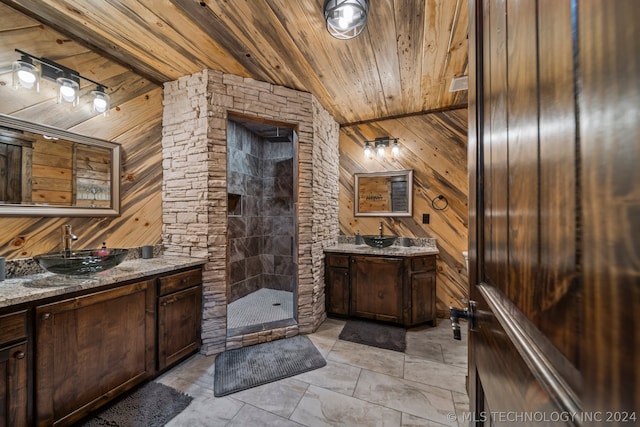 bathroom with tile flooring, wooden walls, a shower, large vanity, and wood ceiling