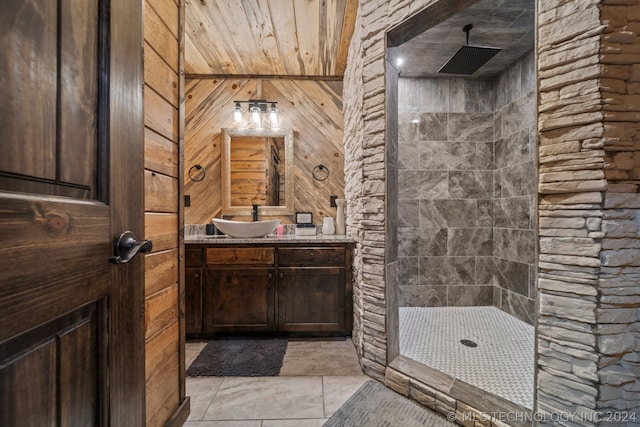 bathroom with walk in shower, tile flooring, vanity with extensive cabinet space, and wooden ceiling