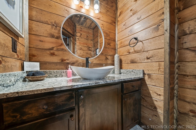 bathroom with wood walls and oversized vanity