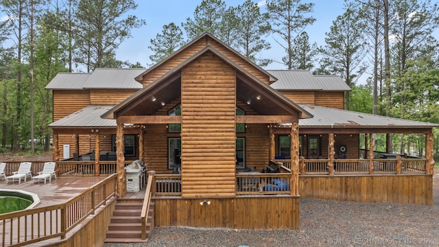 back of house featuring a wooden deck