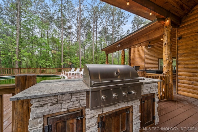 view of patio / terrace with a grill, exterior kitchen, and a wooden deck