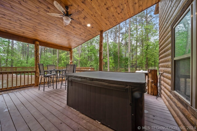 deck with a hot tub and ceiling fan