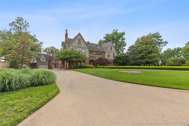 tudor house featuring a front yard